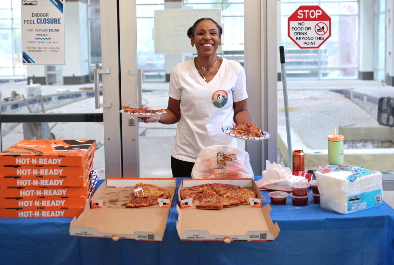 Tracie serving pizza